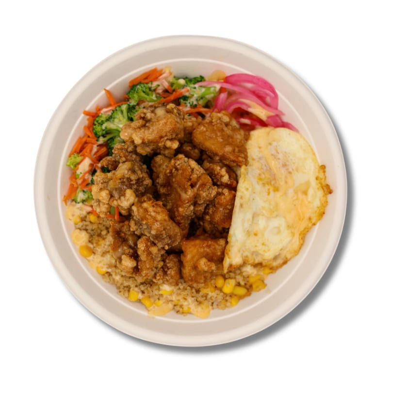Fried chicken bowl with rice, corn, broccoli, carrots, pickled onions, and a fried egg.